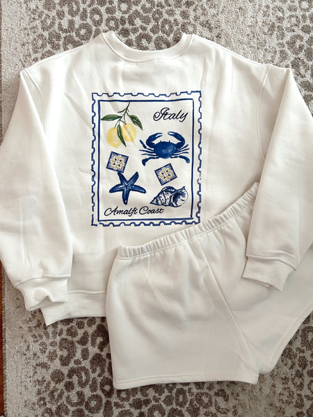 flat lay of Italy Amalfi coast post stamp white sweatshirt with matching shorts